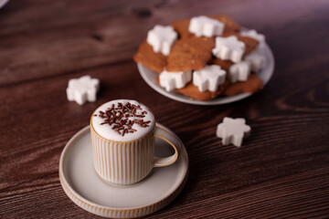 warm cappuccino with chocolate sprinkles and christmas star cookies on rustic wooden table setting with cozy atmosphere, afternoon, inviting, background, wood, texture, festive, holiday, homemade