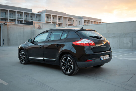 Wroclaw, Poland - August 18, 2025: Three-quarter rear angle of a black Renault Megane TCe on a rooftop car park, highlighting its sleek lines and modern hatchback proportions.