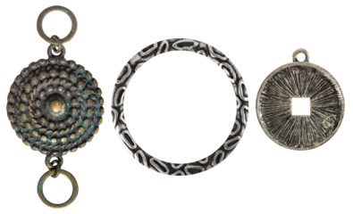 Isolated photo of vintage steel and copper baroque metal decorative ethnic style pendants, brooches, earrings on white background.