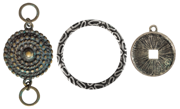 Isolated photo of vintage steel and copper baroque metal decorative ethnic style pendants, brooches, earrings on white background.