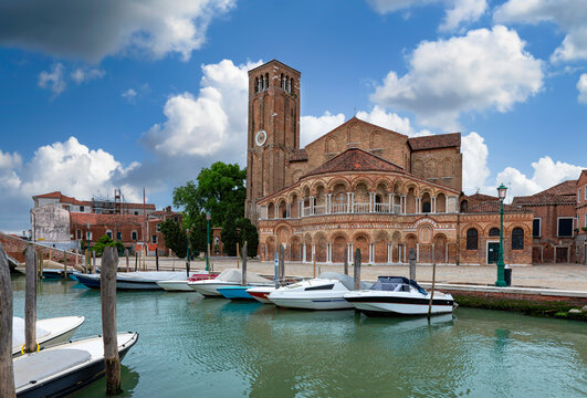 Church of Santa Maria e San Donato and canal with boats in Murano island, Venice, Italy. Architecture and landmarks of Venice. Venice postcard