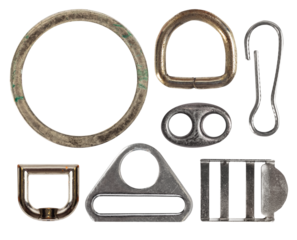 Isolated photo of rusty and worn, vintage and rusty metal cloth buckles and decorative elements on white background.