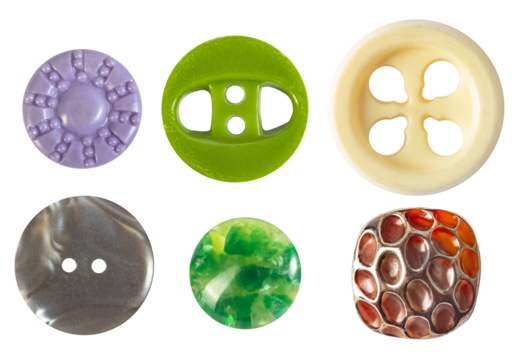 Isolated photo of various colored vintage glass and plastic cloth buttons on white background.