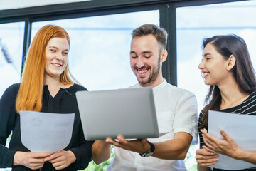 Business team analyzing data and marketing strategy in modern office, brainstorming ideas for project success using laptops and charts, teamwork collaboration for corporate growth