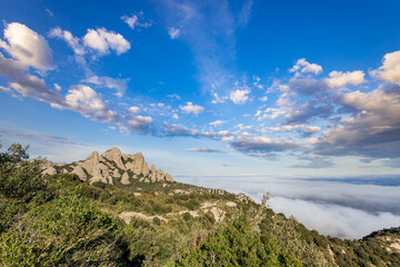 Mountain range is visible in the distance with a cloudy sky