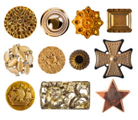 Isolated photo of various vintage bronze and gold metal decorative cloth buttons or rivets on white background.