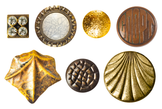 Isolated photo of various vintage bronze and gold metal decorative cloth buttons or rivets on white background.