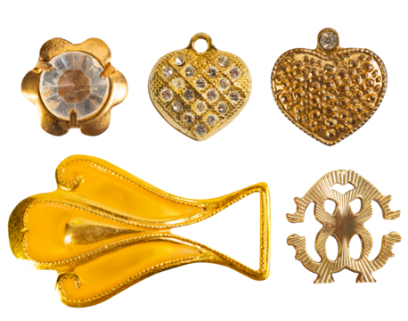 Isolated photo of various vintage bronze and gold metal decorative cloth buttons and pendants on white background.
