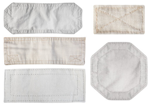 Isolated photo of brown and gray colored denim patches with stitch bordering on white background.