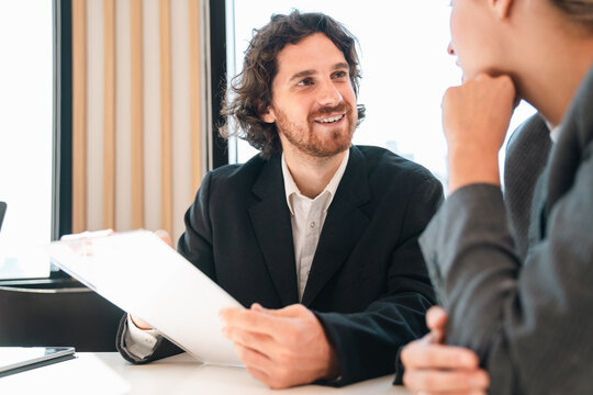 Creative business team meeting with professionals discussing project strategy, presenting ideas on board, teamwork collaboration concept in modern office environment