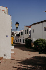 Traditional white houses and narrow streets of Binib&egrave;quer Vell, a picturesque fishing village in Menorca, Spain. Mediterranean charm.
