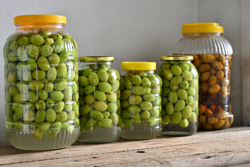 freshly picked green olives in plastic containers