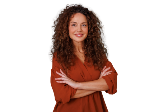 Mature woman with curly hair smiling, arms crossed, portraying confidence, determination, and professional success on transparent background