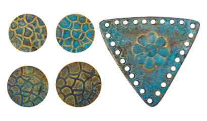 Isolated photo of rusty and worn, vintage copper metal decorative ethnic style pendants, inlays or elements on white background.