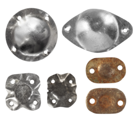 Isolated photo of worn, medieval and rusty metal or steel cloth buttons, inlays, umbo and decorative elements on white background.