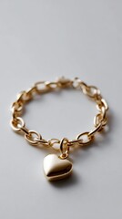 Luxury gold bracelet with heart pendant, plain white background, professional product shot