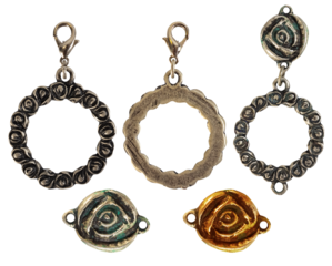 Isolated photo of vintage steel and copper baroque metal decorative ethnic style pendants, brooches, earrings on white background. Rose or flower shape metal elements.