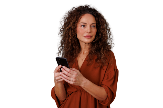 Woman with curly hair holding smartphone looking away, feeling thoughtful or connected, transparent background - Powered by Adobe