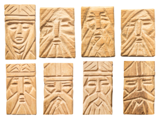 Isolated photo of wood carved ethnic viking face inlays, pendants or decorative elements on white background. Totem pole faces.