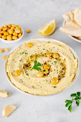 Lupin hummus with herbs and olive oil on white textured background. Vegan protein-rich dip concept.