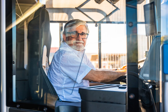 Senior bus driver looking at camera