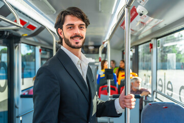 Young man commuting smiling on public bus transport