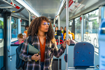 Young woman commuting on public transport bus