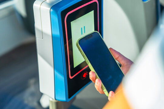 Person paying for public transport using mobile phone