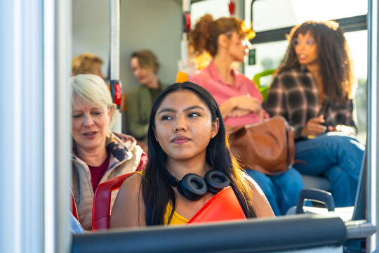 Diverse passengers traveling on a bus, using public transport