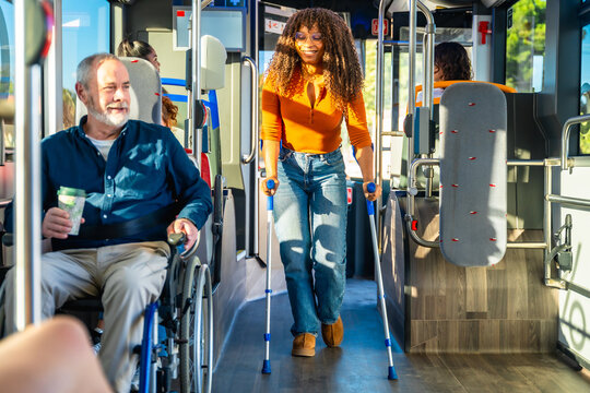 Diverse commuters using accessible public transport bus - Powered by Adobe