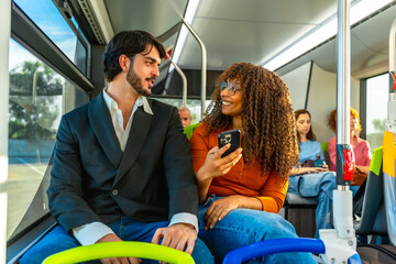 Diverse couple commuting on a bus discussing social media