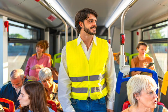 Man in yellow vest standing on public bus