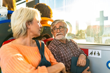 Elderly couple traveling together on public bus