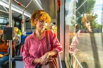 Obraz premium Redhead woman commuting on public transport bus