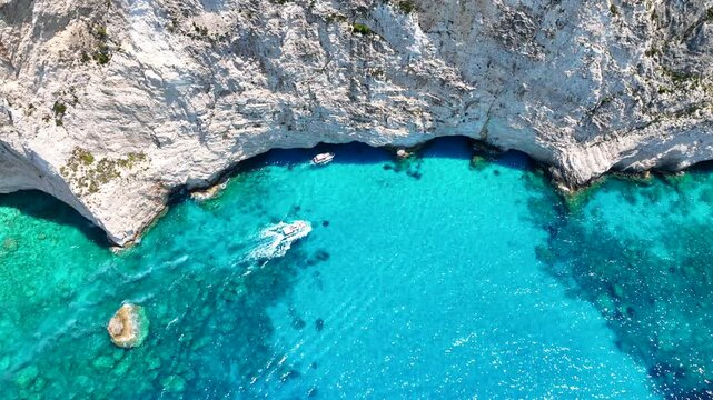 Aerial drone video of scenic turquoise beaches and white rock formations near small port of Porto Vromi an ideal place to start a boat tour near amazing North Zakinthos island, Ionian, Greece