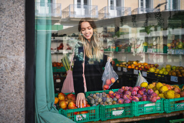 Woman buying fresh fruit at local market