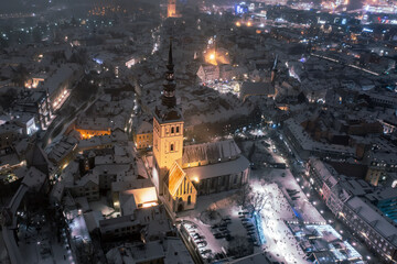 Aerial night View of Tallinn in winter, roofs are covered with snow, Christmas mood