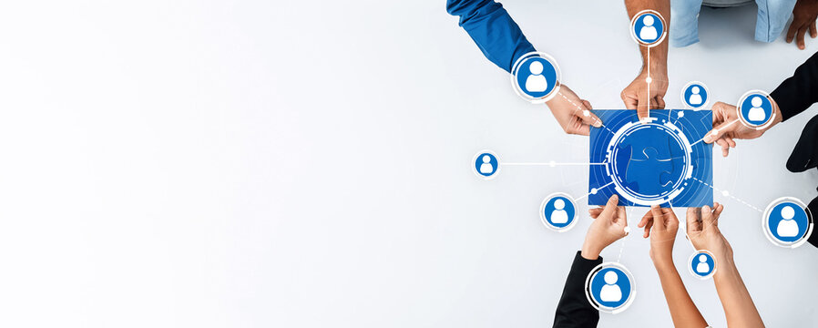 A diverse group engages in an interactive networking session, showcasing their hands above a digital interface, emphasizing collaboration and technological communication. Amity