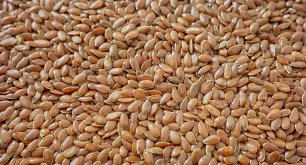 Close up photo of organic flax seeds, selective focus.