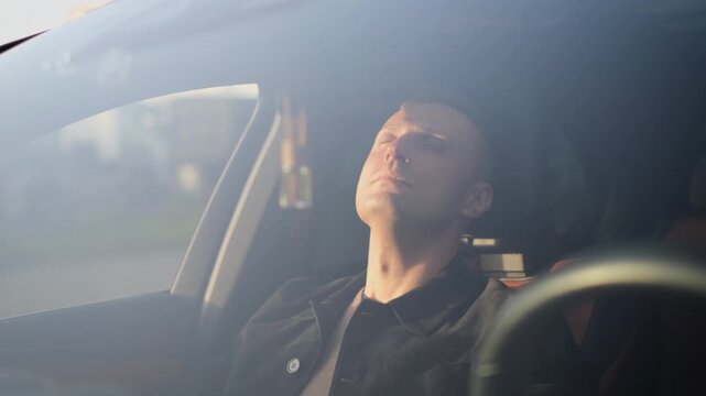 A tired passenger relaxes while sitting in a comfortable car