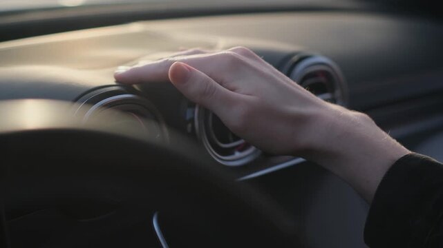 A man evaluates the quality of a car's dashboard by touching it with his hand