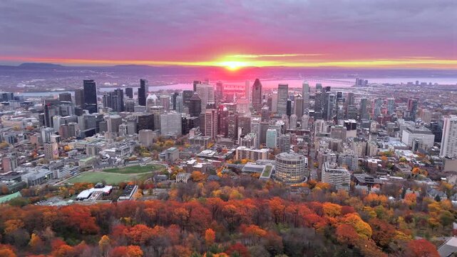 Drone sunrise aerial view of Montreal skyline with autumn foliage