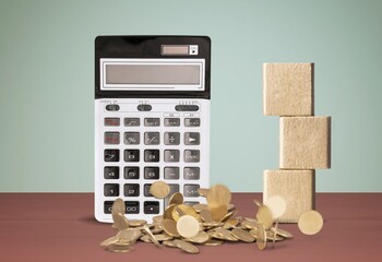 Tax Concept on Wooden Blocks and Calculator on desk