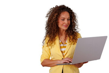 Naklejka premium Professional businesswoman in yellow blazer working on laptop, managing business remotely, smiling, transparent background
