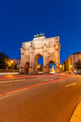 Illuminated Siegestor Memorial Arch at Night and Car Light Trails. Munich, Bavaria, Germany