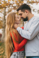 Naklejka premium lovers sharing moment, intimate couple with gentle touch among tall trees and fallen leaves