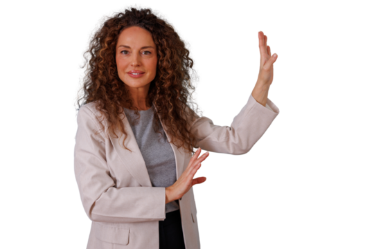Businesswoman with curly hair demonstrating a screen, a concept or a product, using hand gestures with a bright smile