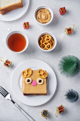 Berry jam peanut butter sandwich in the form of deer for Christmas holidays on a white background