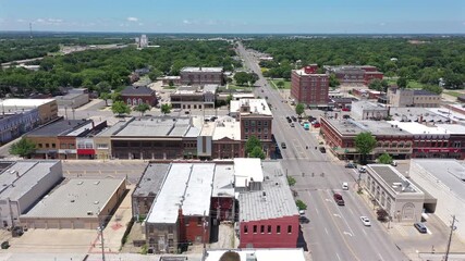 Emporia, Kansas, USA - June 18, 2023: Afternoon traffic passes through the urban core of downtown Emporia.