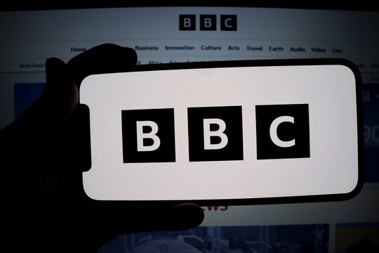 Salvador, Brazil - November 17, 2025: BBC logo on smartphone screen with BBC website in the background. British Broadcasting Corporation is a British public service broadcaster. 